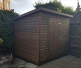 Sheds_ 8ft x 6ft pent shed in loglap_2c treated dark brown and fitted with a key lock