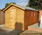 Sheds_ A 10ft x 8ft Apex shed in matchboard_2c treated light brown_2c polyester felt_2c toughened glass and a key lock. Fitted in Sawley