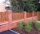 F35 - Feather edge fence panels in between brick columns