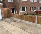 A fence finished off nicely with a sloping panel and matchboard gate.