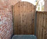 Arched matchboard gate with key lock fitted in Sawley.